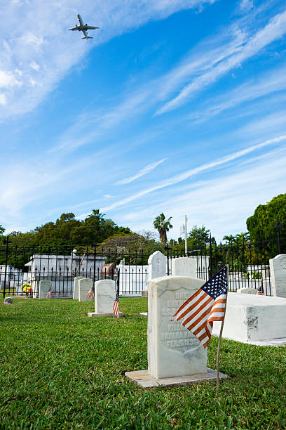 U.S.S. Maine sailor grave in Key West Florida Key West, Florida, USA - January 17, 2015: A commercial jet descends for landing in Key West, Florida, flying over the grave of an unknown sailor who died in the explosion aboard the U.S.S. Maine in Havana Harbor, Cuba, on February 15, 1898. havana harbor photos stock pictures, royalty-free photos & images