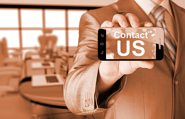 istock business man hand holding smartphone with the message contact us 534028507