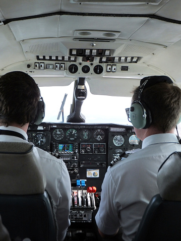 Vancouver, Сanada - February 20, 2011: Pilot and copilot inside a cockpit of a small airplane - Flying from Vancouver International Airport to Tofino Airport, Cancouver Island.