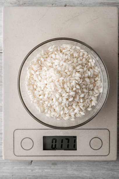 istock Rice in the glass bowl on the scale vertical 534029064