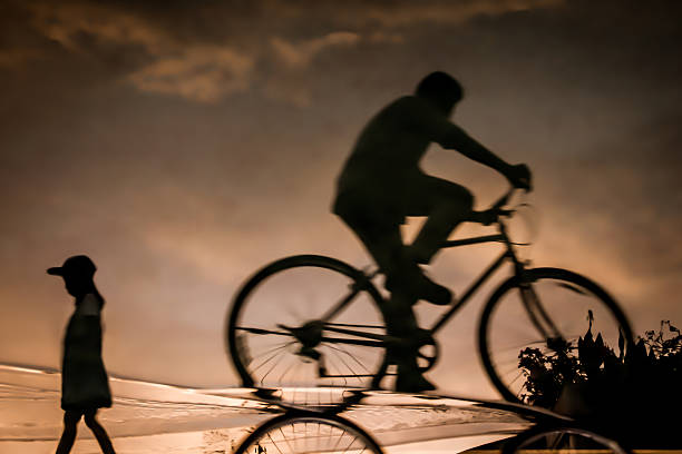 istock Blur technique of cyclist on the road with reflection 534029776