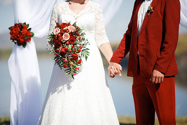 Wedding in style Marsala color. Bride and groom holding hands stock photo