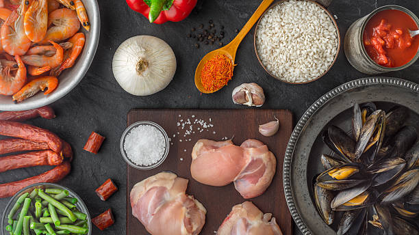 istock Ingredients for paella on the dark stone table top view 534030482