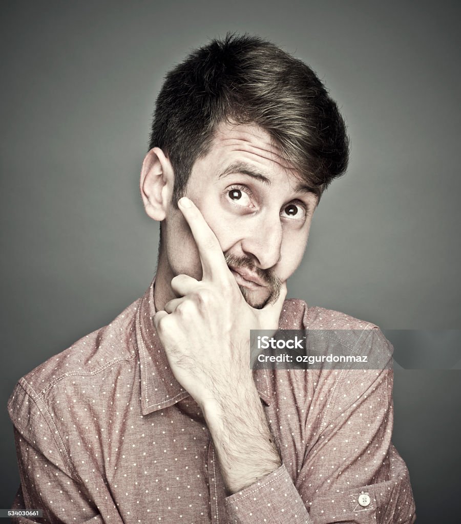 Thinking young man Portrait of a young man thinking,studio shot 2015 Stock Photo