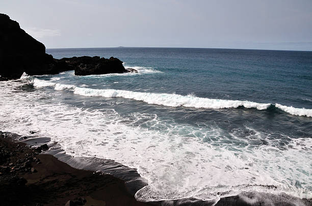 istock Black sand beach of Pisqueiro with waves 534030987