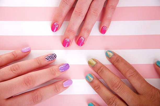 Three womens hands with beautiful colored nails stock photo
