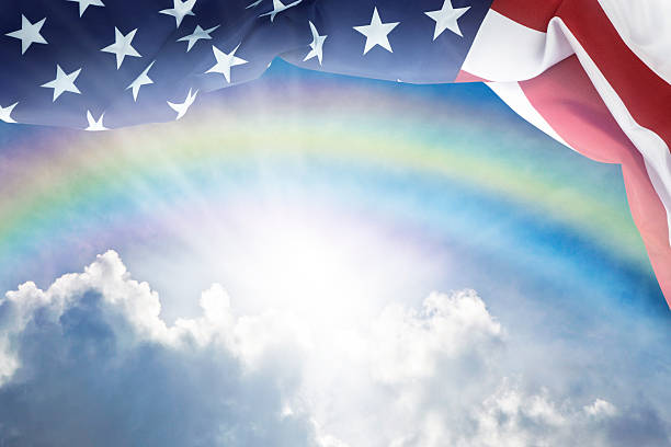 istock American Flag Under Blue Sky With Rainbow 534032176