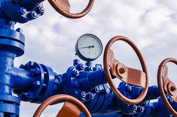 Wellhead Wellhead with valves and manometer. Oil and gas concept. machine valve photos stock pictures, royalty-free photos & images