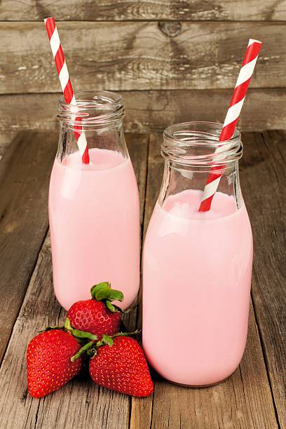 istock Strawberry milk in bottles on wood 534033787