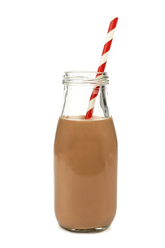 Chocolate milk with straw in a traditional bottle isolated on white