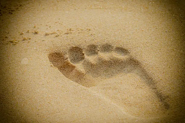 Footprint on the golden sand beach