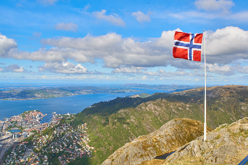 Bergen landmark, Ulriken mountain views in a cloudy day, with strong winds. White clouds in the sky and amazing visibility. Wide angle shot.