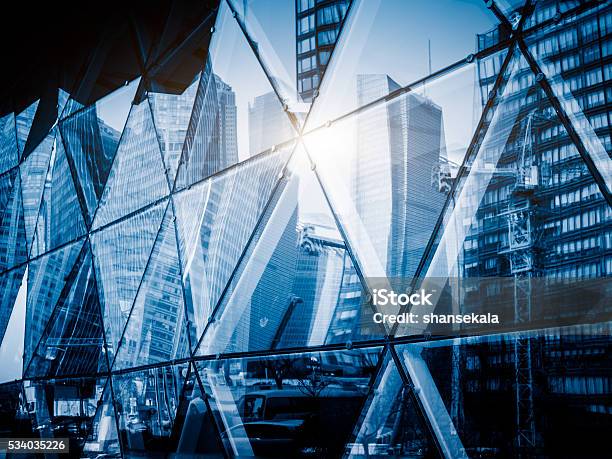 View Of A Modern Glass Skyscraper Reflecting The Blue Sky Stock Photo - Download Image Now