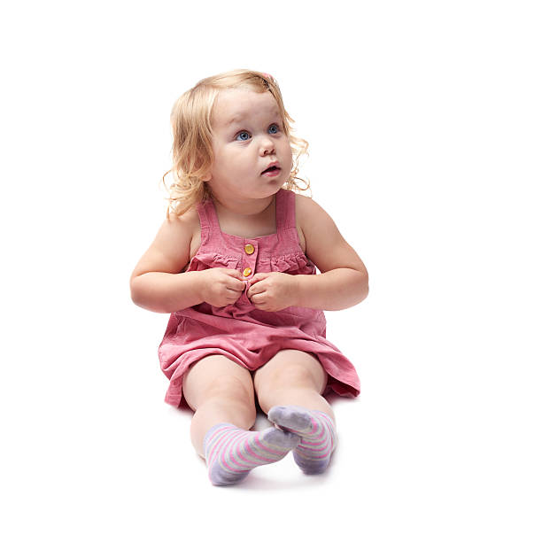 istock Young little girl sitting over isolated white background 534035610