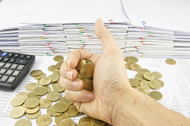 istock Gold coins in hand signal by thumb 534035851