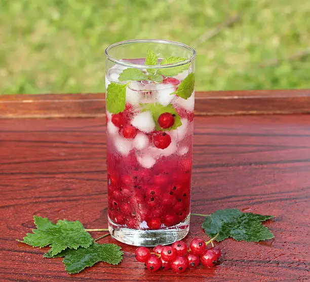 Refreshing summer drink with redcurrant and mint