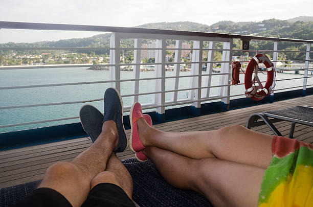 jambes sur le pont en jamaïque - deck chair photos et images de collection