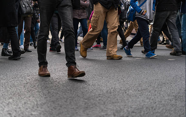 istock Large group of people walking on walkway 534044382