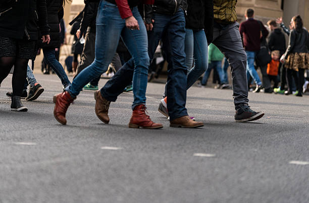 istock Large group of people walking on walkway 534044560