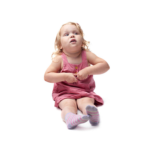istock Young little girl sitting over isolated white background 534044832