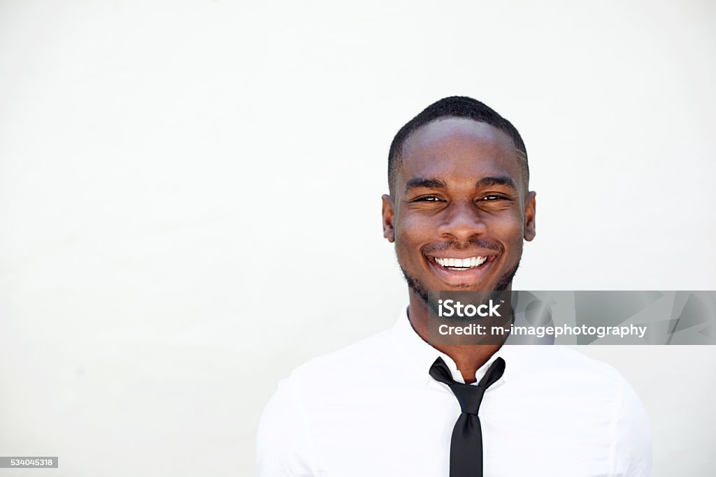 Portrait of smiling young african businessman Close up portrait of smiling young african businessman in white shirt and tie White Background Stock Photo