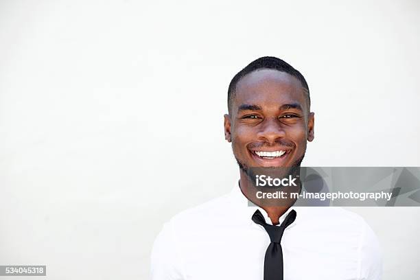 Portrait Of Smiling Young African Businessman Stock Photo - Download Image Now - White Background, African Ethnicity, Black Color