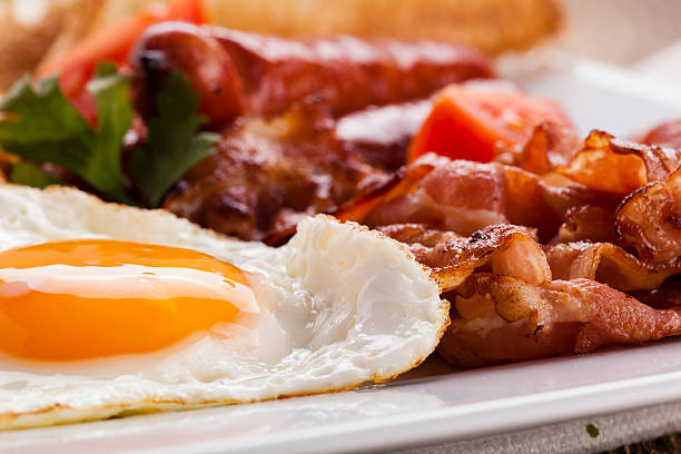 istock Full english breakfast with bacon, sausage, fried egg, baked bea 534045709
