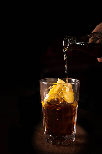 istock Barman prepares Cuba libre cocktail in a tall glass 534046543