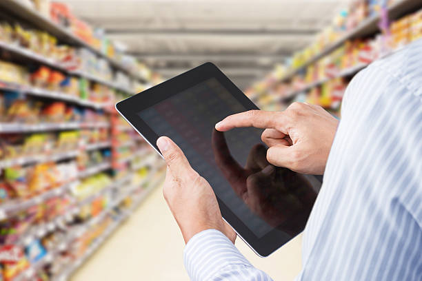 istock Businessman checking inventory in minimart on touchscreen tablet 534047271