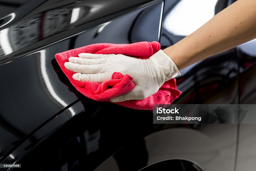 Car detailing series : Cleaning black car Closeup of hand cleaning black car Car Stock Photo