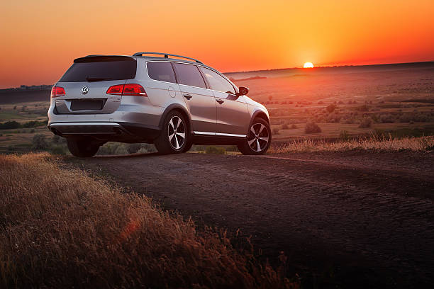 Grey car Volkswagen Passat stay on dirt road stock photo