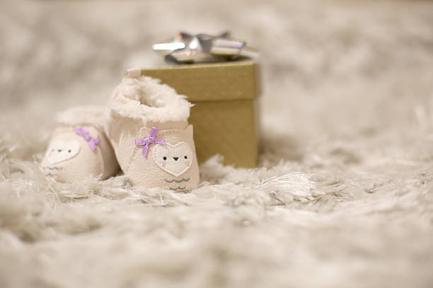 Little baby infant playing adult in mother's heel shoes