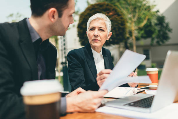 istock Businesspeople Sitting Outdoors And Using Laptop. 534048112