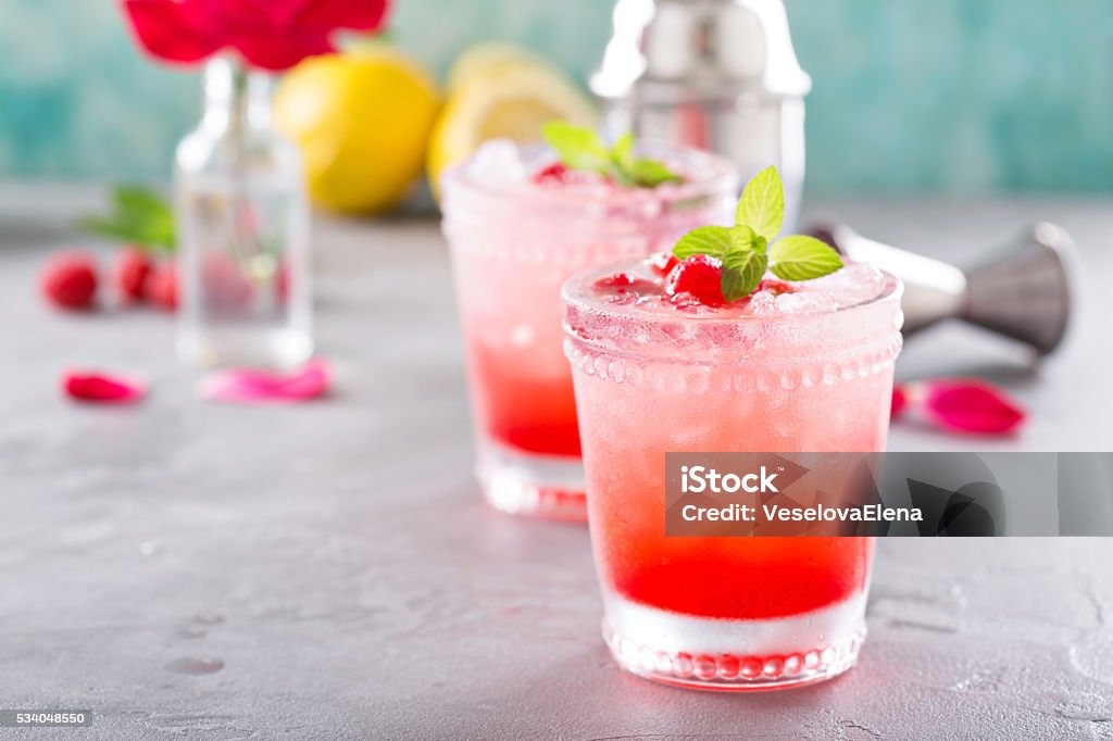 Raspberry ice cocktail Raspberry crushed ice cold refreshing cocktail with mint Backgrounds Stock Photo