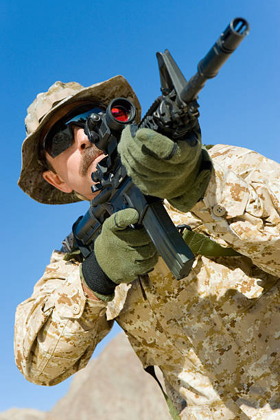 istock Soldier Aiming Through Gunsight Against Blue Sky 534049149