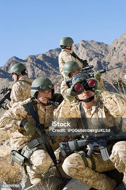 Soldiers With Rifles And Binocular Patrolling During War Stock Photo - Download Image Now