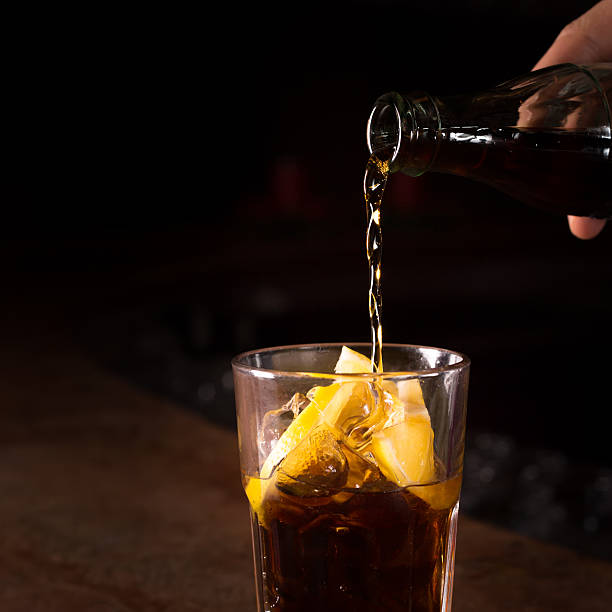 istock Barman prepares Cuba libre cocktail in a tall glass 534049183