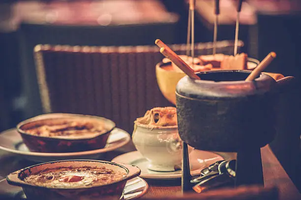 Parisian street cafe with an earthenware pot (caquelon) for fondue