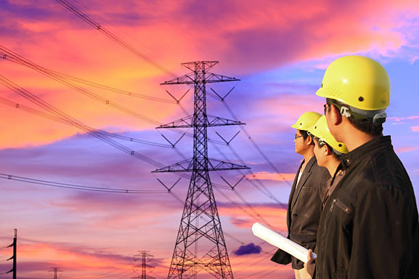istock engineers standing at electricity station, discussing plan 534050569