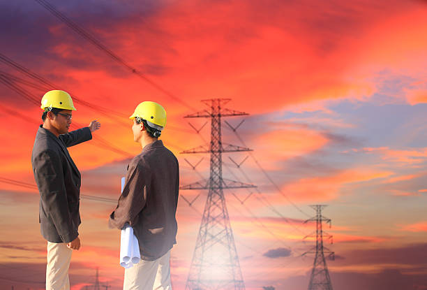 istock engineers standing at electricity station, discussing plan 534050575