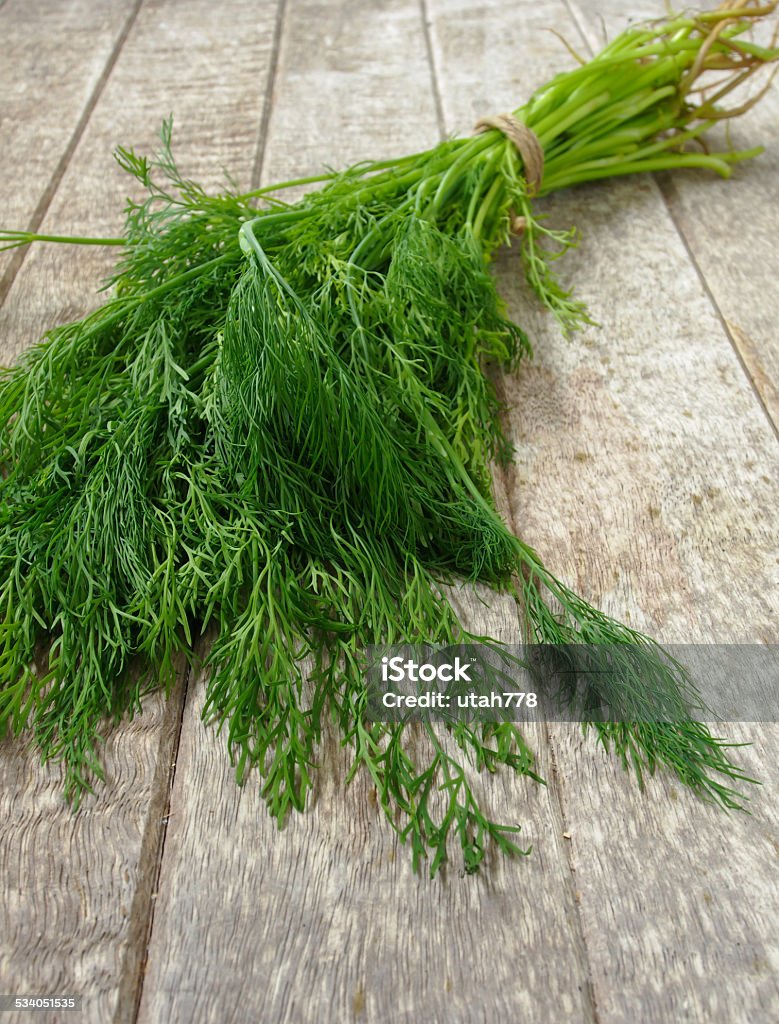 dill Dill is placed on a wooden table. 2015 Stock Photo