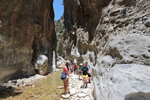 Crete hiking Crete, Greece - May 21, 2014: Tourists hike in Samaria Gorge in Crete, Greece. The national park is a UNESCO Biosphere Reserve since 1981. lefka ori photos stock pictures, royalty-free photos & images