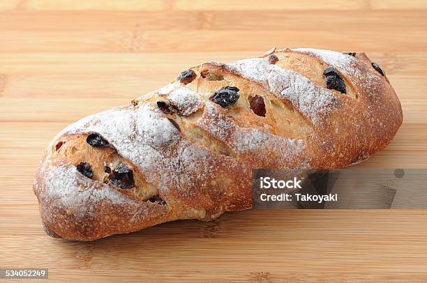 French Baguette Bread With Raisin Isolated On Cutting Board Stock Photo - Download Image Now