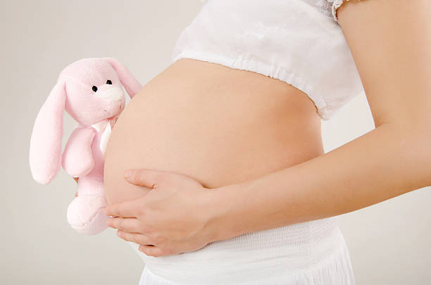 istock Close up on pregnant belly with toy. 534052479