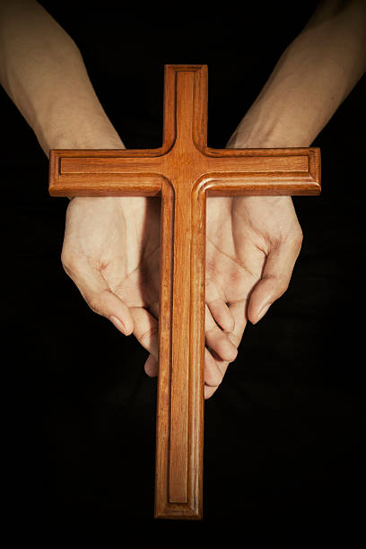 istock Hands with wooden cross on the palms 534052523