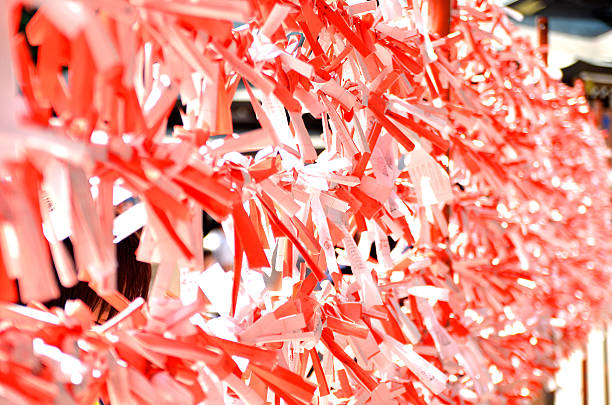 Paper fortune In Enoshima Shirine many paper fortune(called Omikuji) is knotted. sagami bay photos stock pictures, royalty-free photos & images