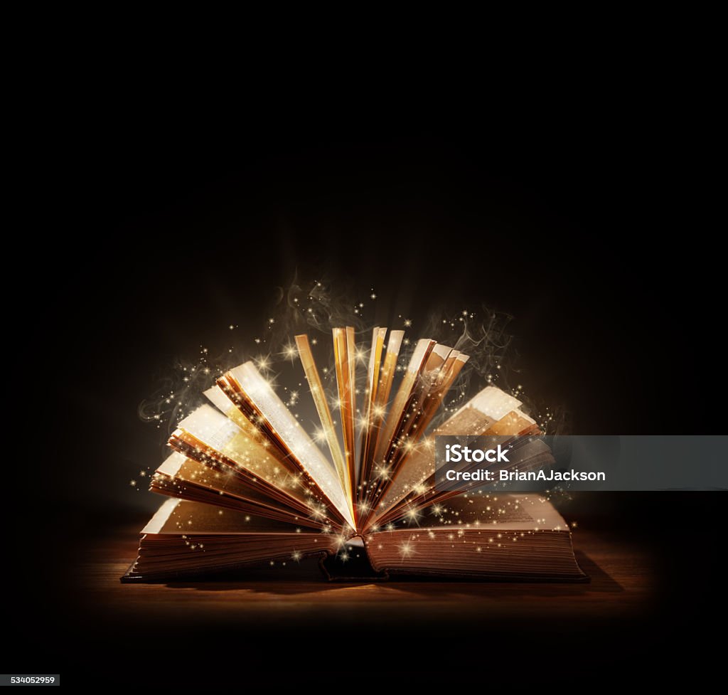 Magical book or bible The magic of reading, storytelling and education or bible and religion, Black background space above for text message or copy. Book Stock Photo