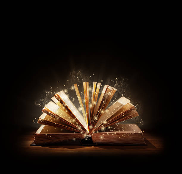 Magical book or bible The magic of reading, storytelling and education or bible and religion, Black background space above for text message or copy. book cover photos stock pictures, royalty-free photos & images