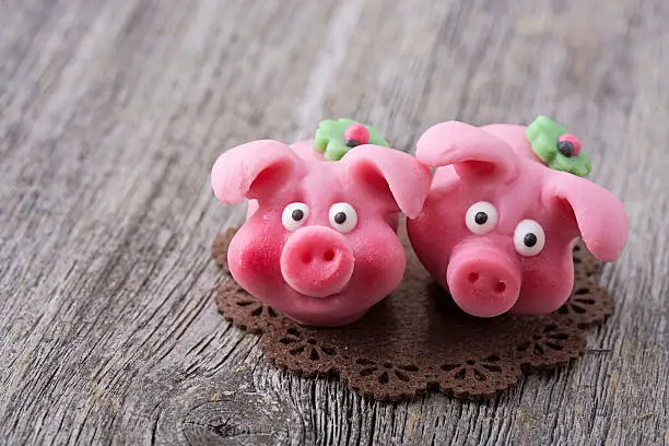 Marzipan pig on wooden background