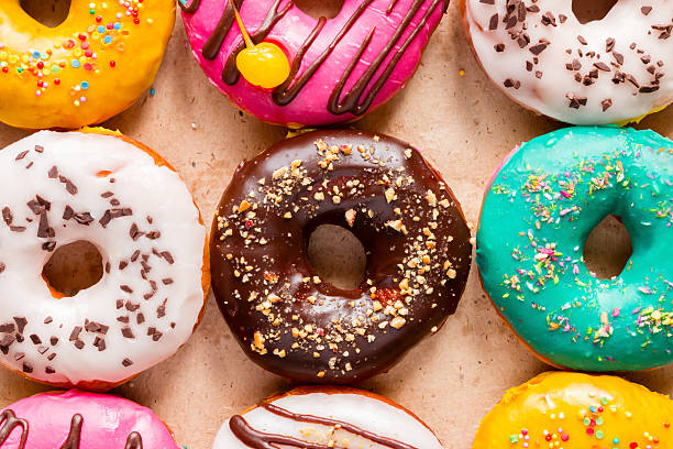 istock tasty donuts on paper close up 534053376